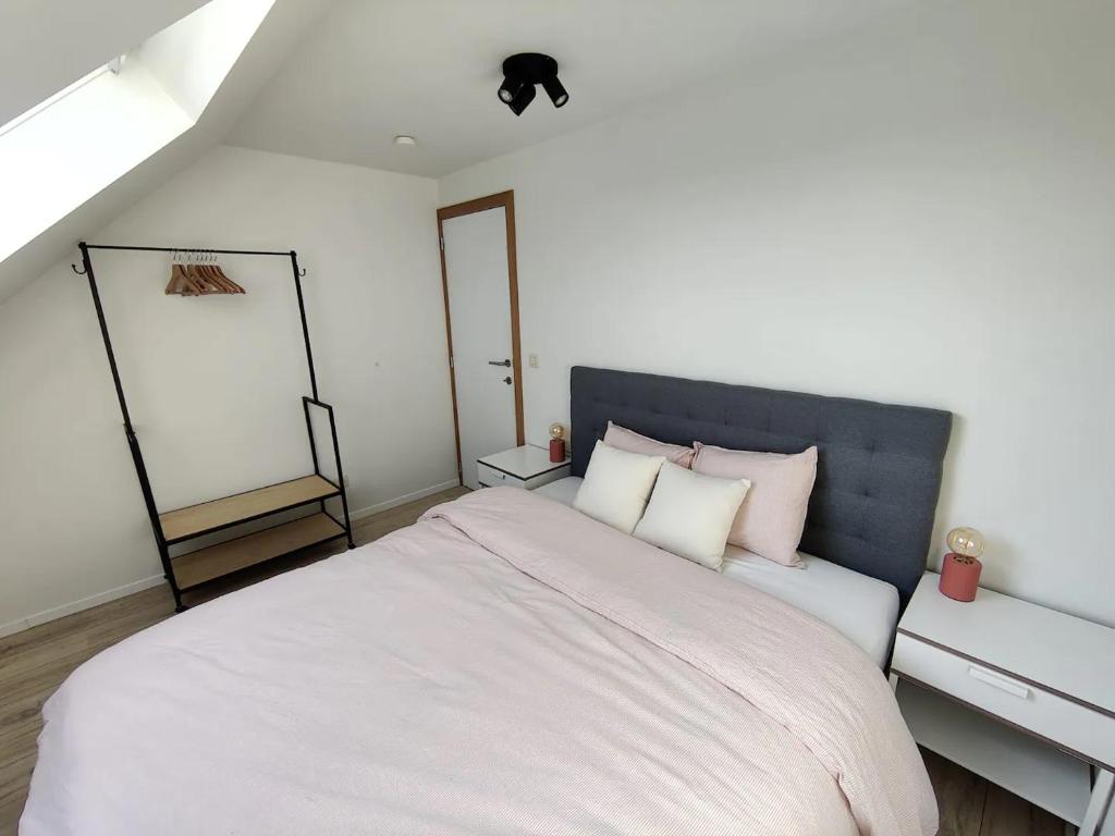 布鲁日Bel-etage Bruges Homestay - Free parking - Entire floor的卧室配有一张带白色床单和枕头的大床。