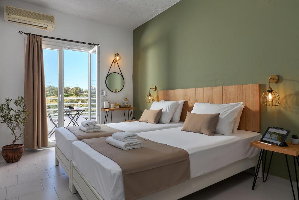 赫索尼索斯Charm Hotel, Hersonissos的一间带大床的卧室和一个阳台