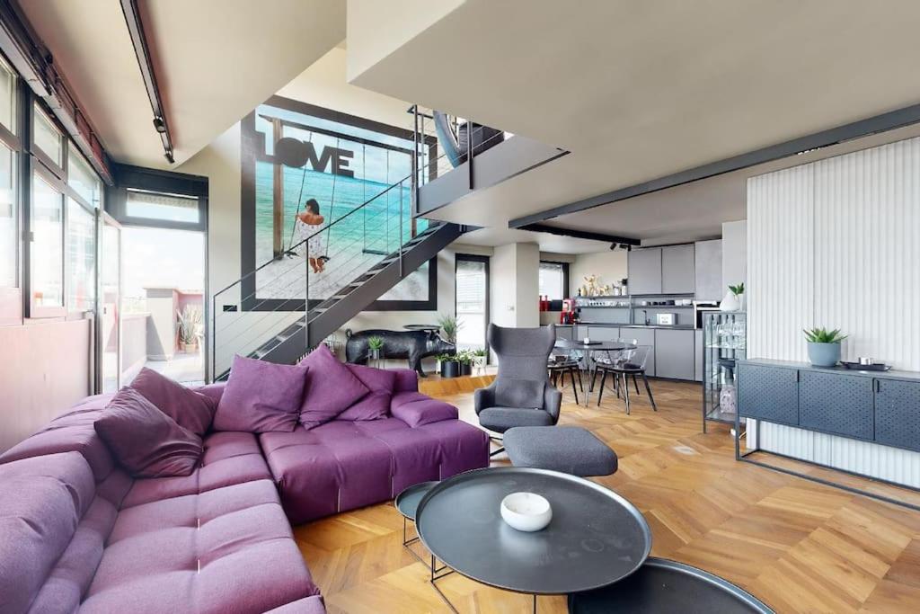 布拉迪斯拉发Štýlový loft s ohromnou terasou的客厅配有紫色沙发和桌子