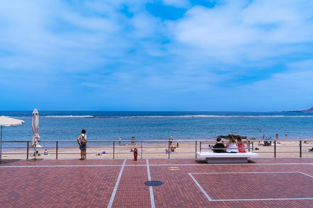 大加那利岛拉斯帕尔马斯1linea Canteras的海滩上有人坐在海边的长凳上