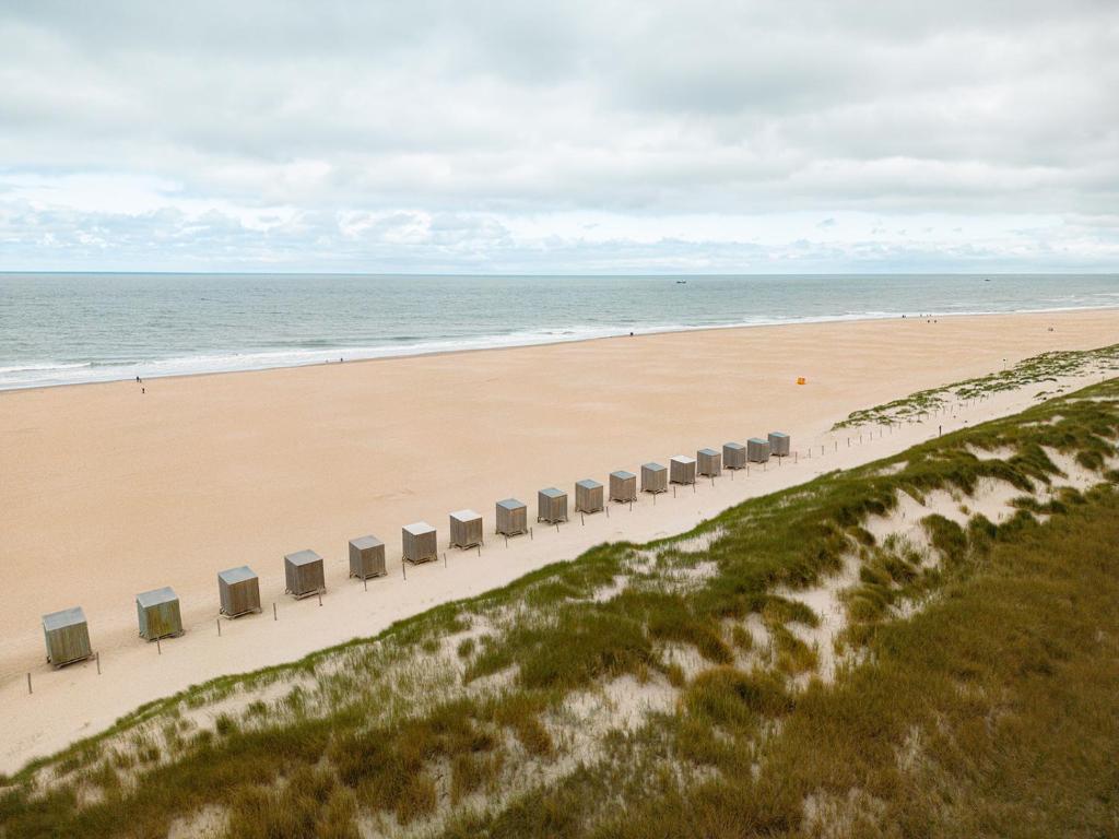 卡兰茨奥赫Glamping Callantsoog的海滩的空中景色,设有一排椅子