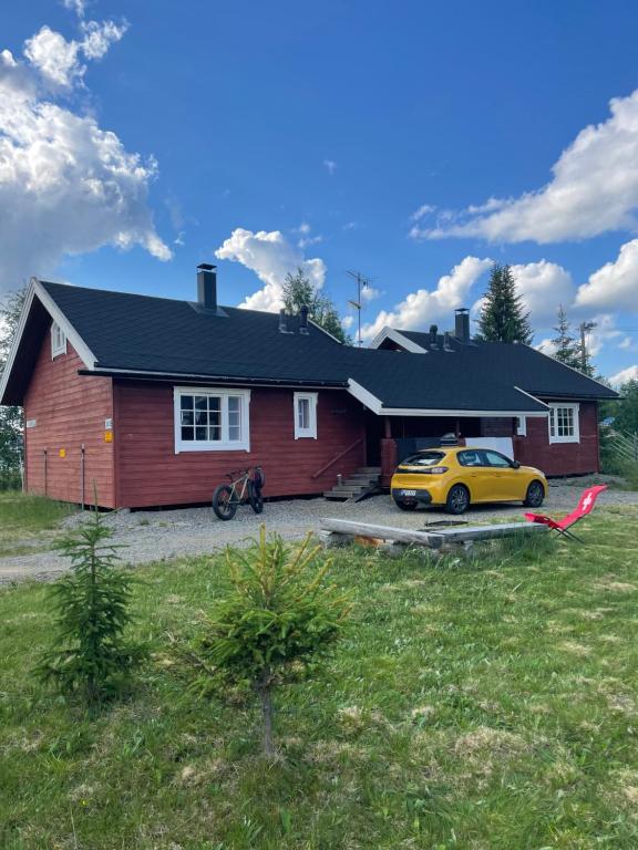 科拉里Yllästölli 2 A, Äkäslompolo的门前有一辆黄色汽车的房屋