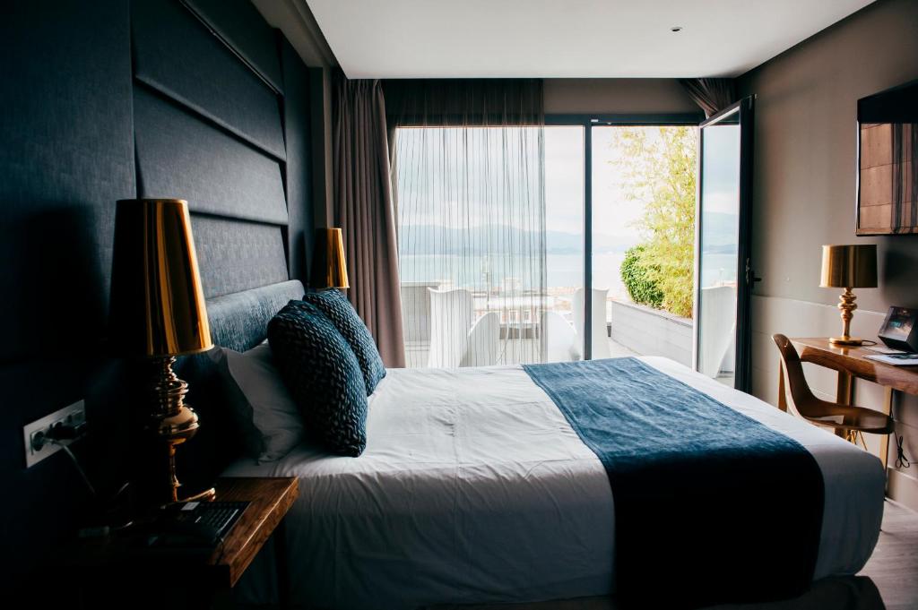 桑坦德Hotel Art Santander的一间卧室设有一张床,享有海景