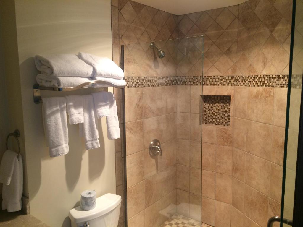 BeldingCandlestone Golf and Resort的带淋浴、卫生间和毛巾的浴室