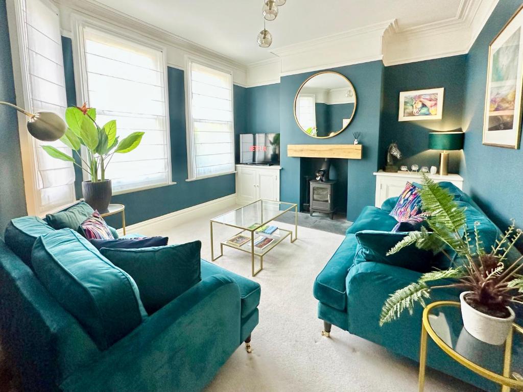 约克Montrose House的客厅配有2张蓝色沙发和镜子