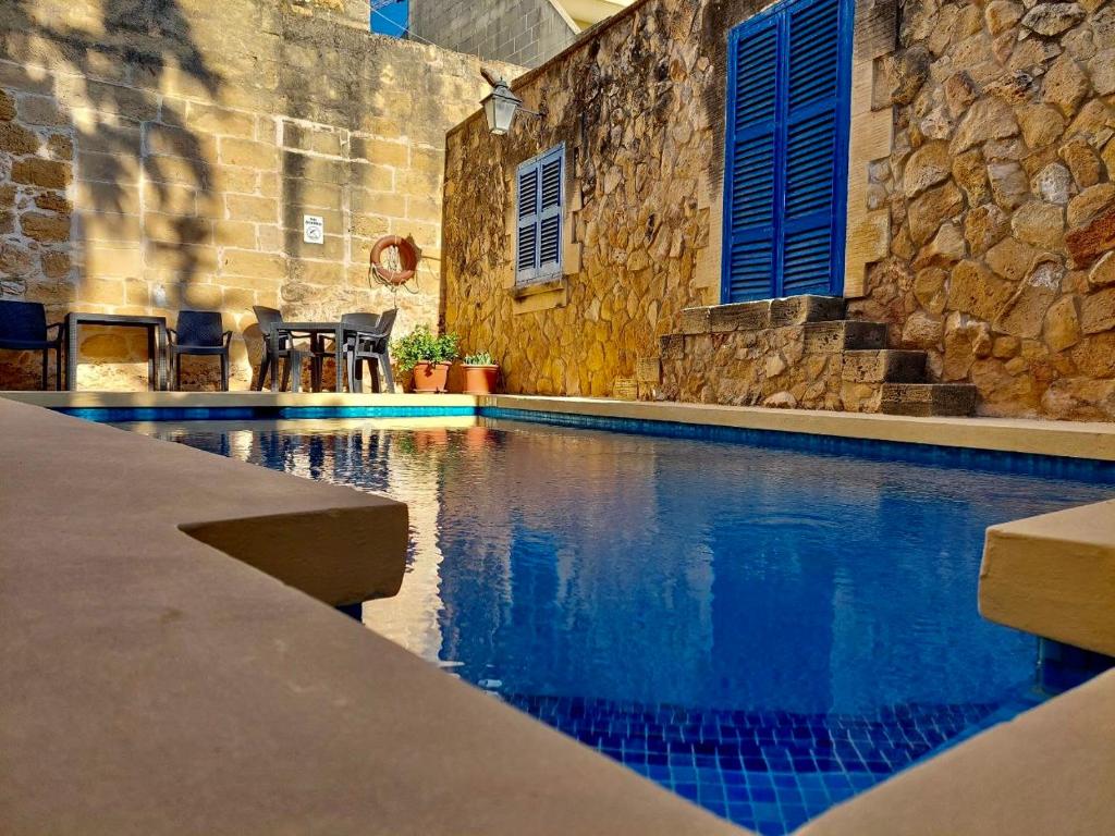 沙拉MJ Farmhouse B&B的一座石墙房子内的游泳池
