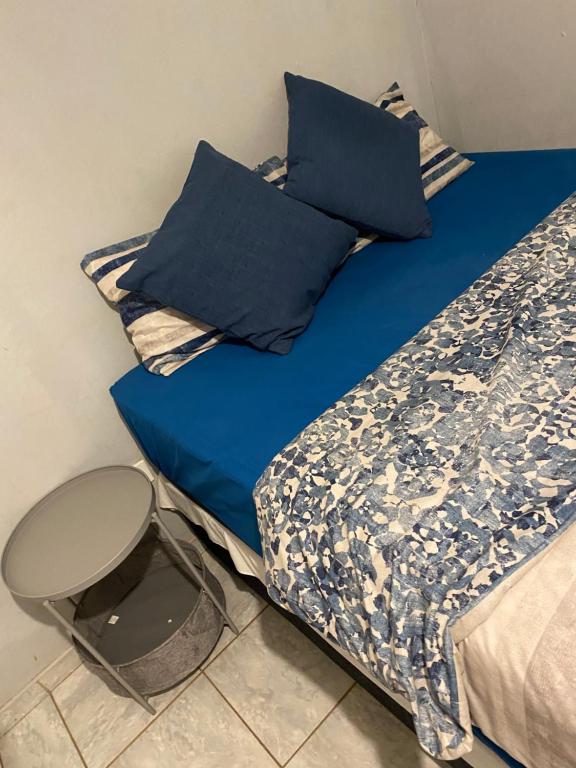 楚梅布Alvin's House的一张带蓝色床单和蓝色枕头的床