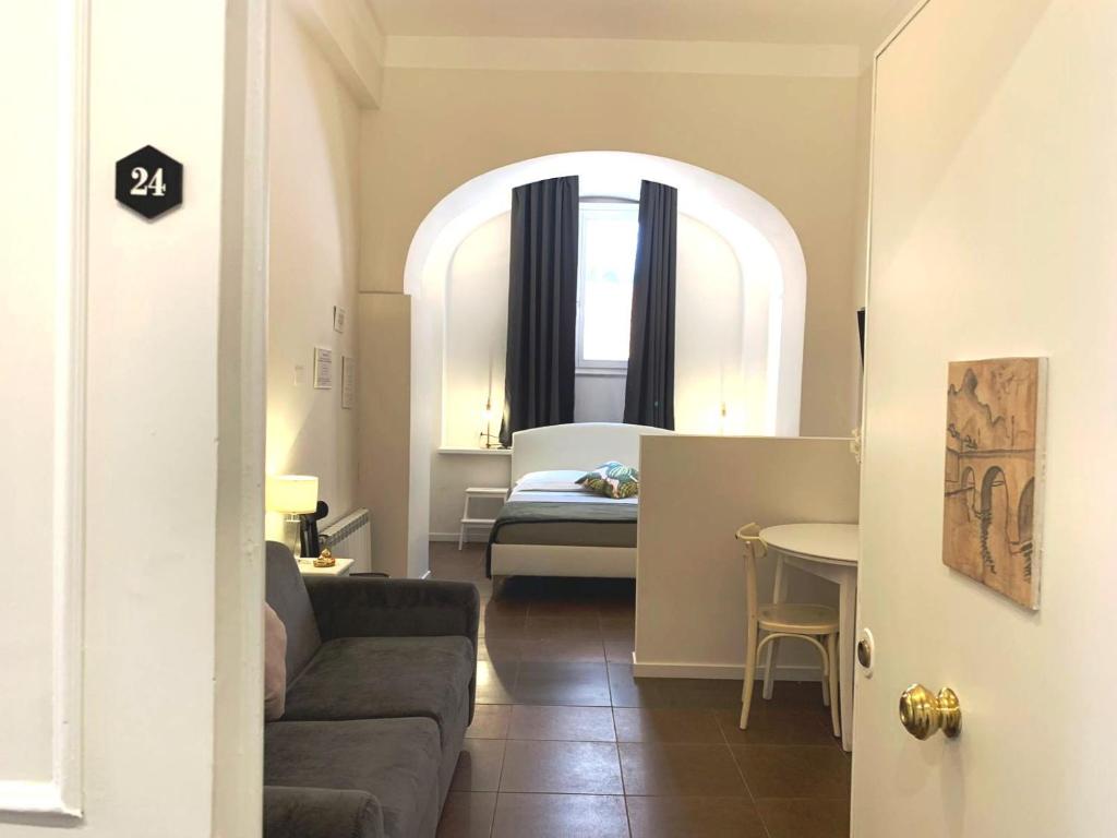 罗马Eccelso Suites的带沙发的客厅和卧室