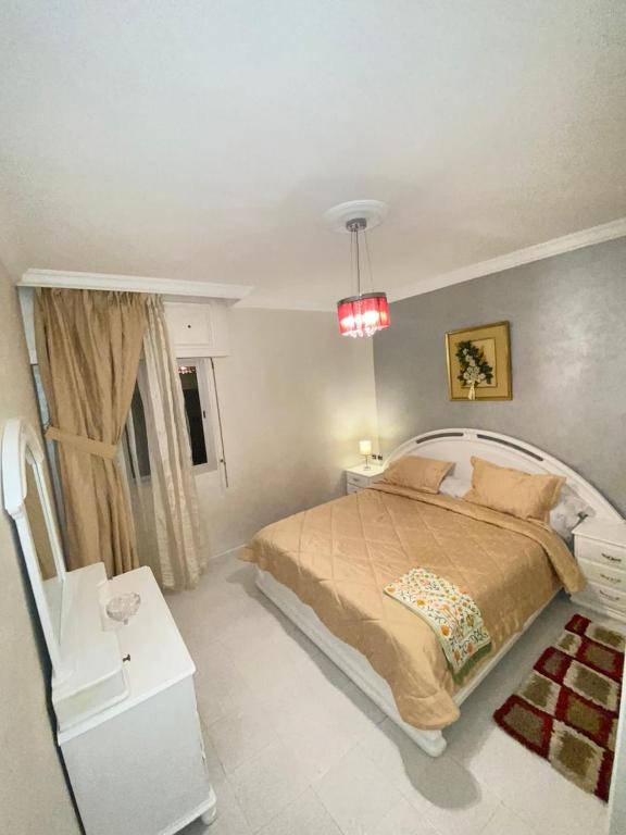 胡塞马Centre ville appartement的一间卧室设有一张大床和一个窗户。