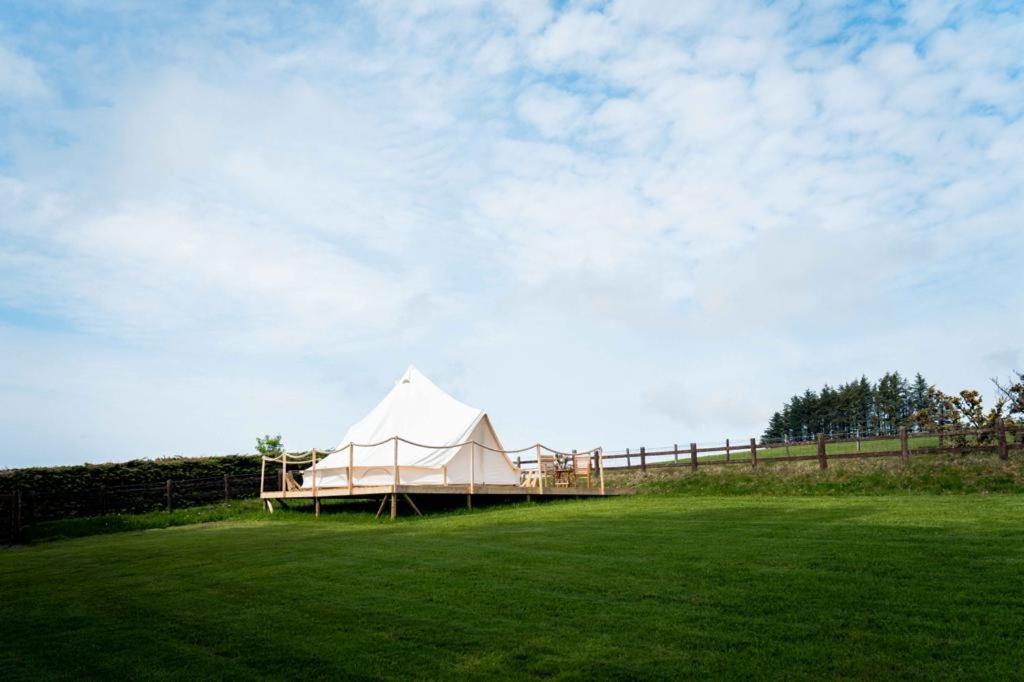 Cross InnHafod Hir的田野上的白色帐篷,带栅栏