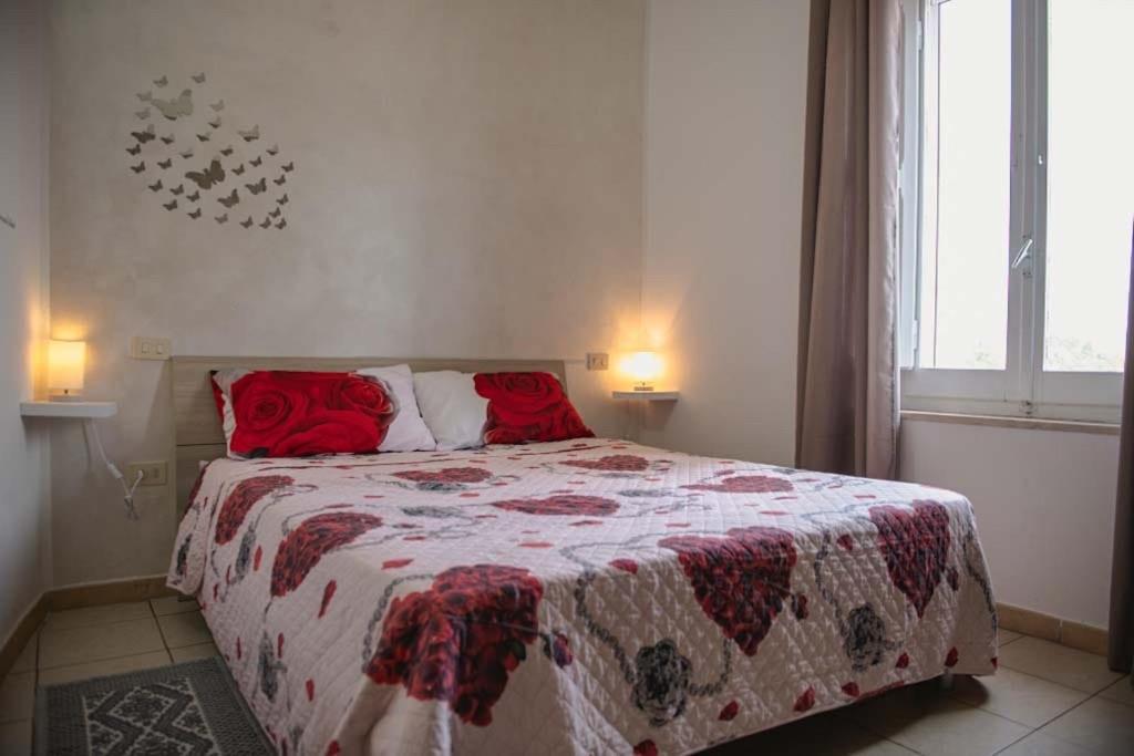 Le MarmoreCasa Vacanze Le Cascate的一间卧室配有一张带红色枕头的床