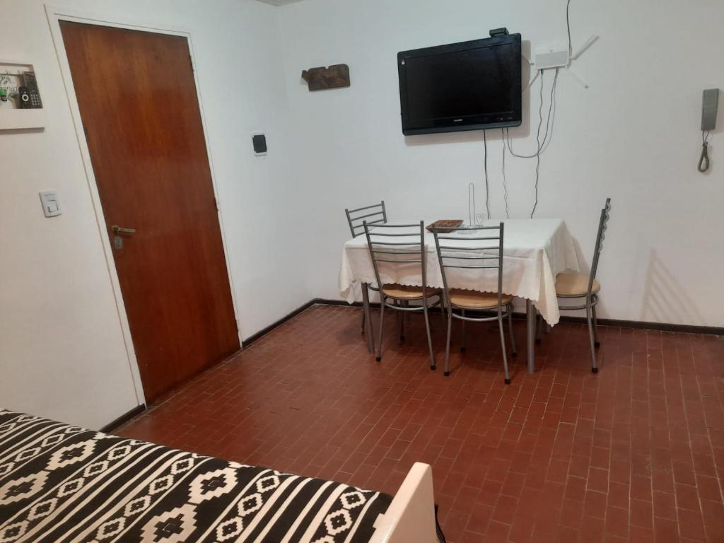 门多萨CONSORCIO ARIZU的一间带桌椅和电视的用餐室