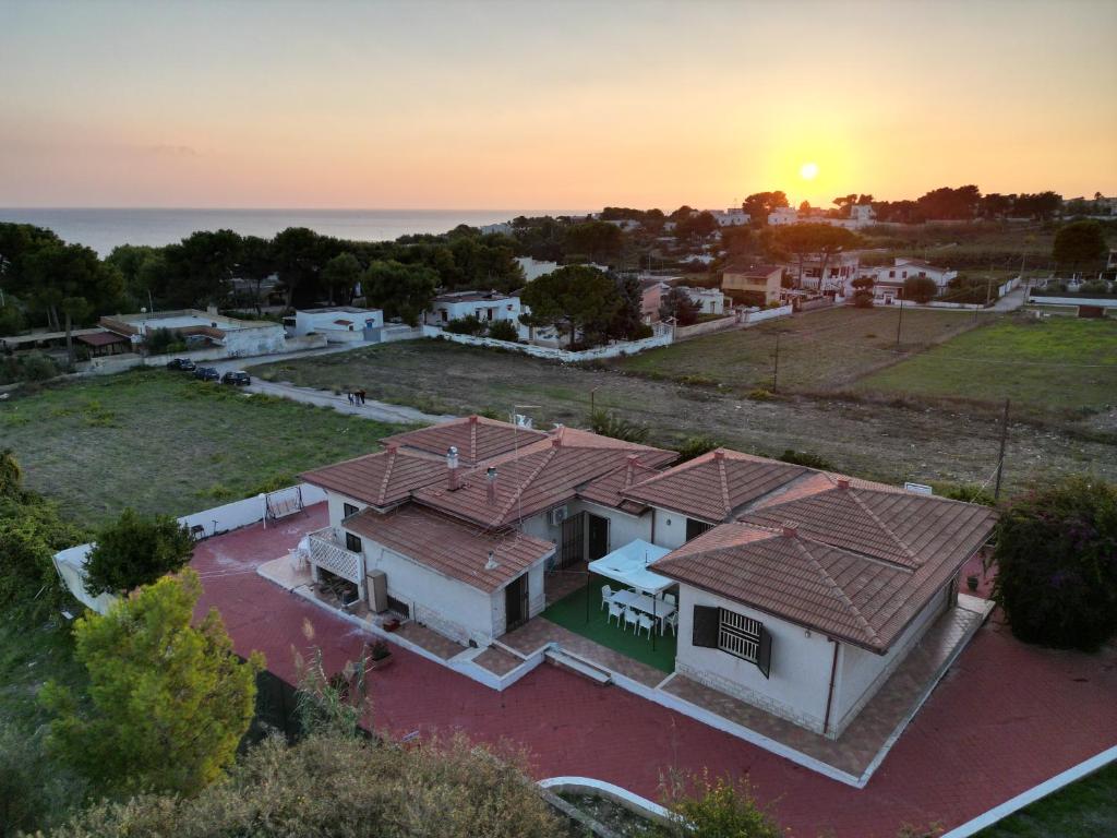 莱波拉诺Villa Ada的享有房子的空中景色,背景是日落