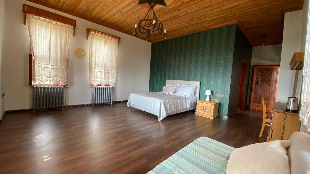 阿拉尼亚Stone Room的卧室配有白色的床,铺有木地板