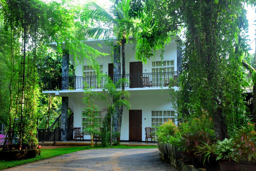 达瓦拉维Imperial Resort的前面有树木的白色建筑