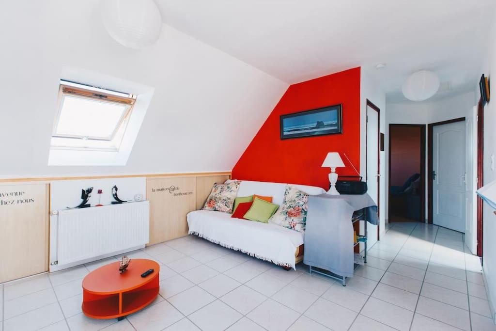 普洛戈Appartement - Plogoff Pointe du Raz的带沙发和红色墙壁的客厅