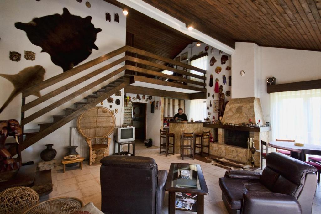 Križevci卡佩塔诺瓦旅馆的客厅配有家具和木制天花板。