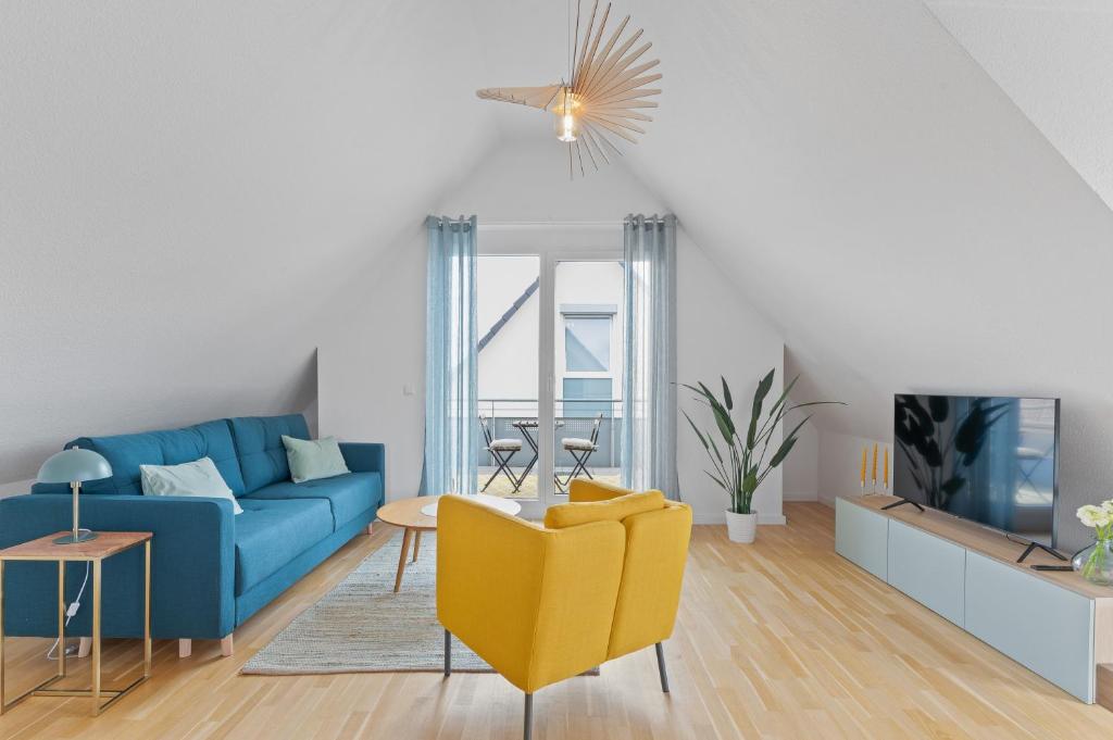 莱因费尔登-埃希特尔丁根Design-Apartment - Küche - Balkon - Tiefgarage的客厅配有蓝色的沙发和黄色的椅子