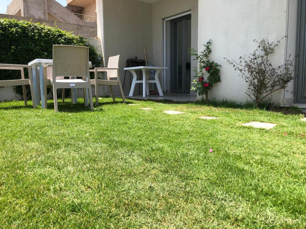 纳布勒Villa Karim的草地上带桌椅的庭院