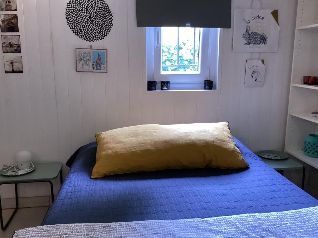 南特Maisonnette Nantes的一间卧室设有蓝色的床和窗户。