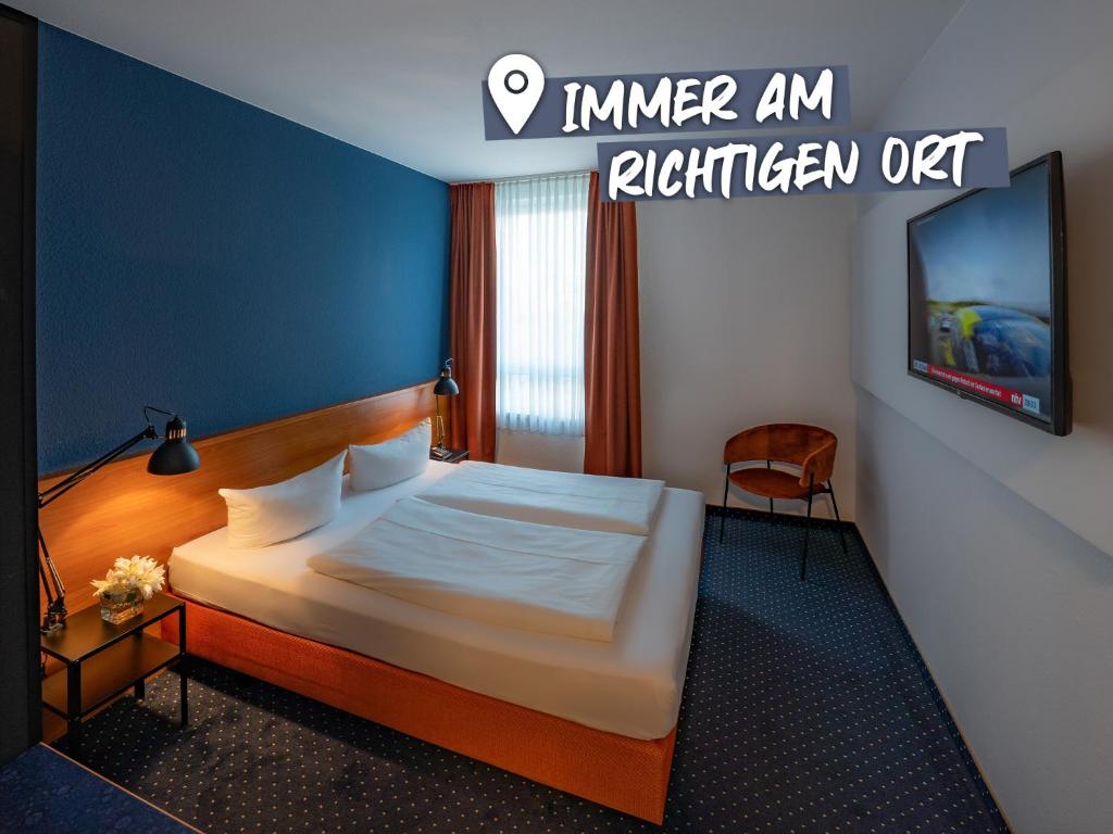 德累斯顿ACHAT Hotel Dresden Altstadt的配有一张床和一台平面电视的酒店客房