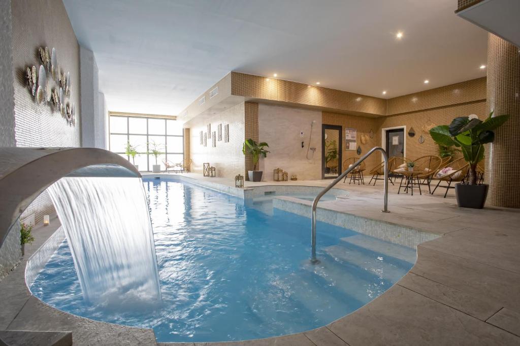戛纳伊甸园酒店&Spa的一座带瀑布的游泳池