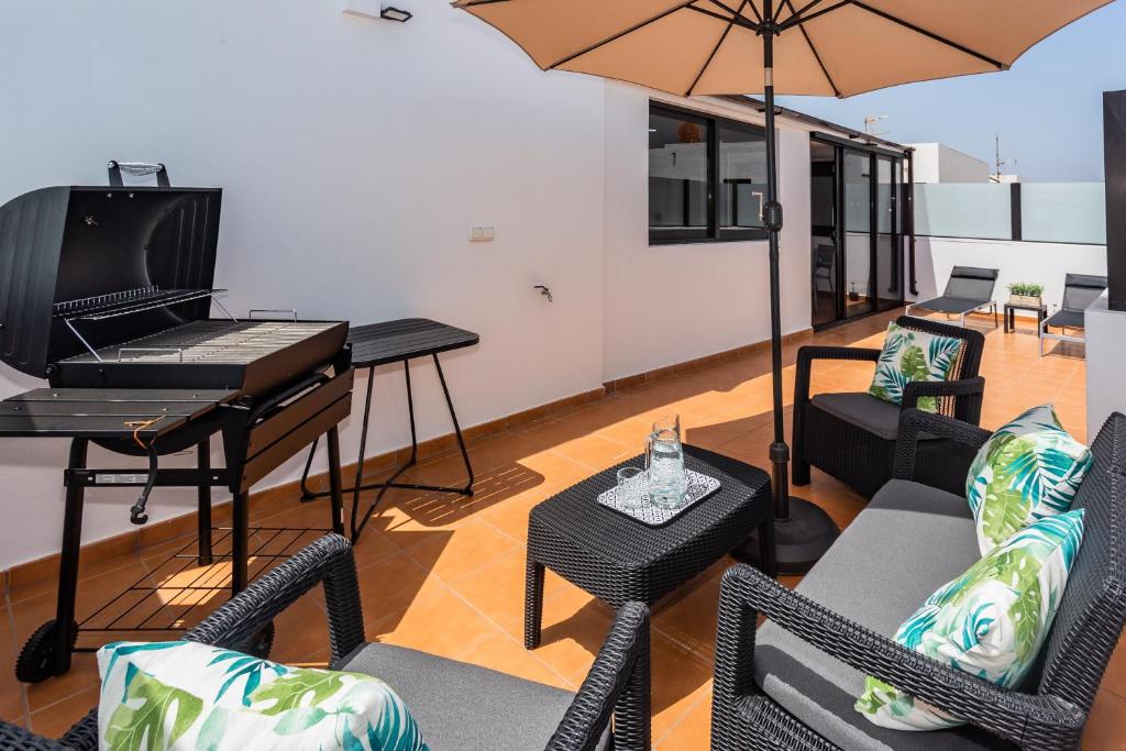 宏达海滩Eslanzarote ECO TANA HOUSE, super wifi, Tv satélite, Bbq的客厅配有钢琴和椅子