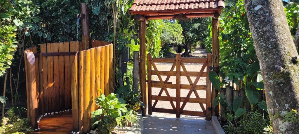 卡拉伊瓦Pousada NÔ Caraíva的通往带凉亭的木门的入口