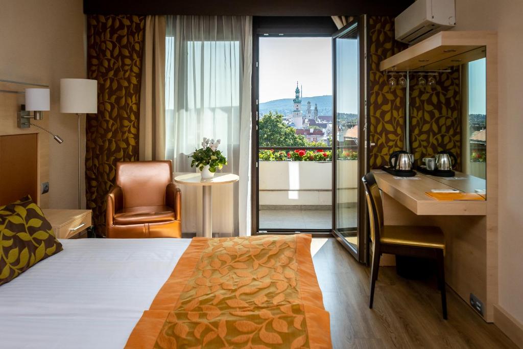 索普隆索普朗酒店的酒店客房配有一张床、一张书桌和一间厨房。