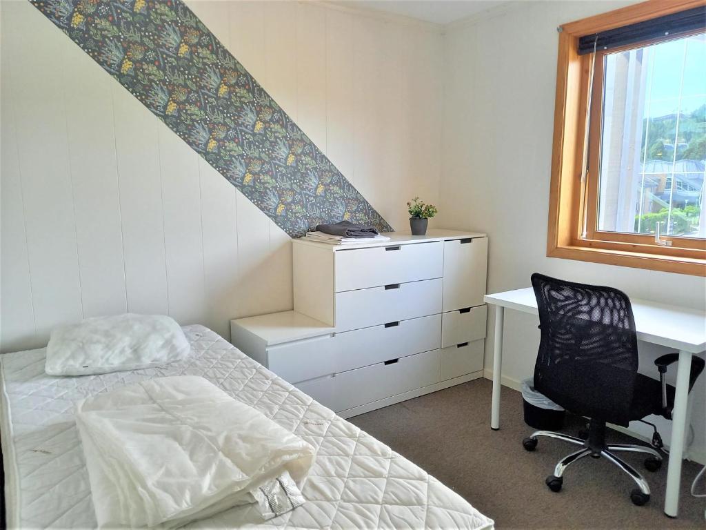 维尼斯拉Single room with shared spaces的一间卧室配有一张床、一张书桌和一个窗户。
