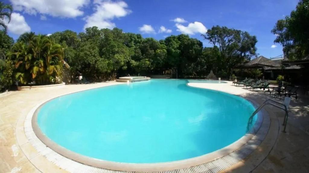 马哈赞加SUNNY HOTEL MAHAJANGA的一个种有树木的大型蓝色游泳池