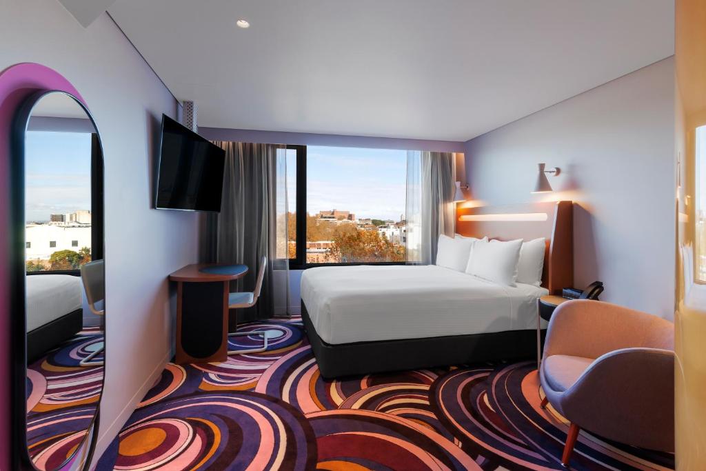 悉尼Adge Hotel and Residences的酒店客房设有一张床和一个大窗户
