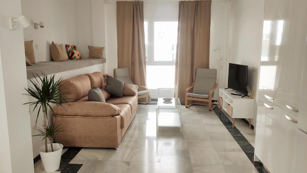 科尼尔-德拉弗龙特拉El Rincón de Madera - Apartamento céntrico en Conil的带沙发和电视的客厅