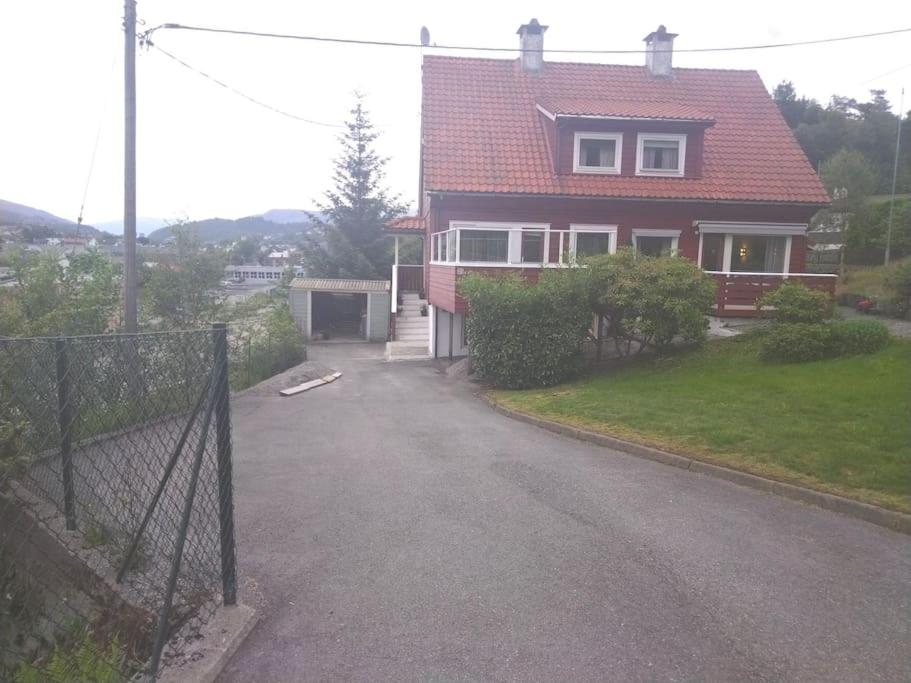 卑尔根Kjellerleilighet i Fana til leie的车道前有围栏的房子