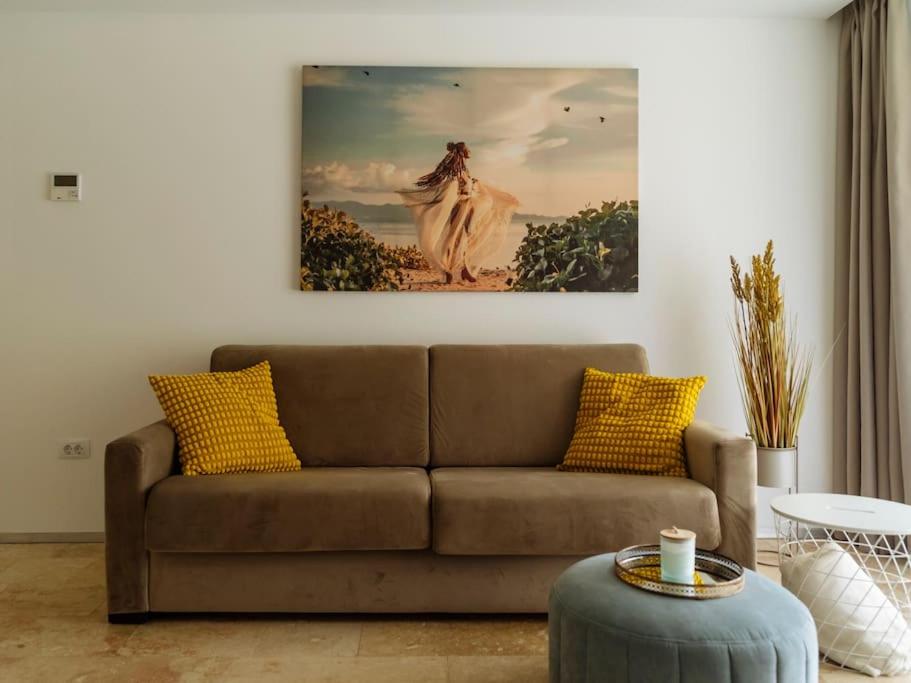奥林普Bond Apartment - Astria Olimp的客厅配有沙发和墙上的绘画