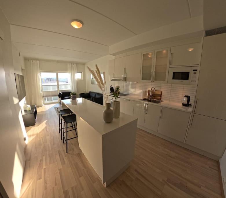 阿尔塔Apartment in city center的一间白色的大厨房,在房间内有一个小岛