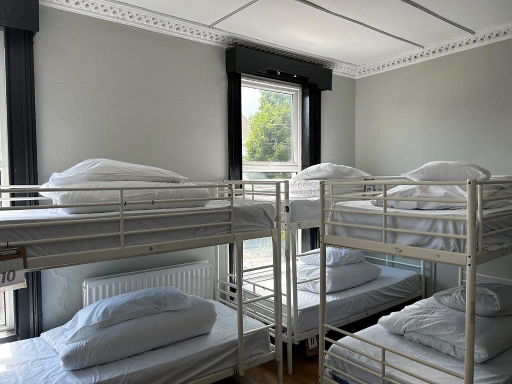 贝尔法斯特Lagan Backpackers的客房设有四张双层床和窗户。
