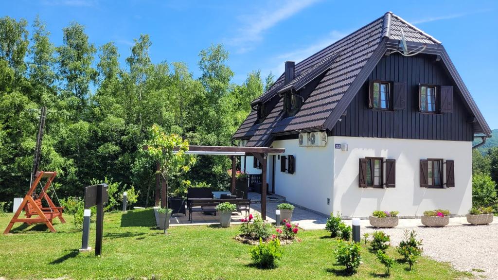 普利特维采村B&B Plitvice Lakes Villa Mija的一间黑色屋顶的小房子