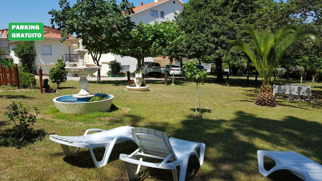 阿兰扎达考斯特拉酒店的一个带白色椅子和喷泉的庭院
