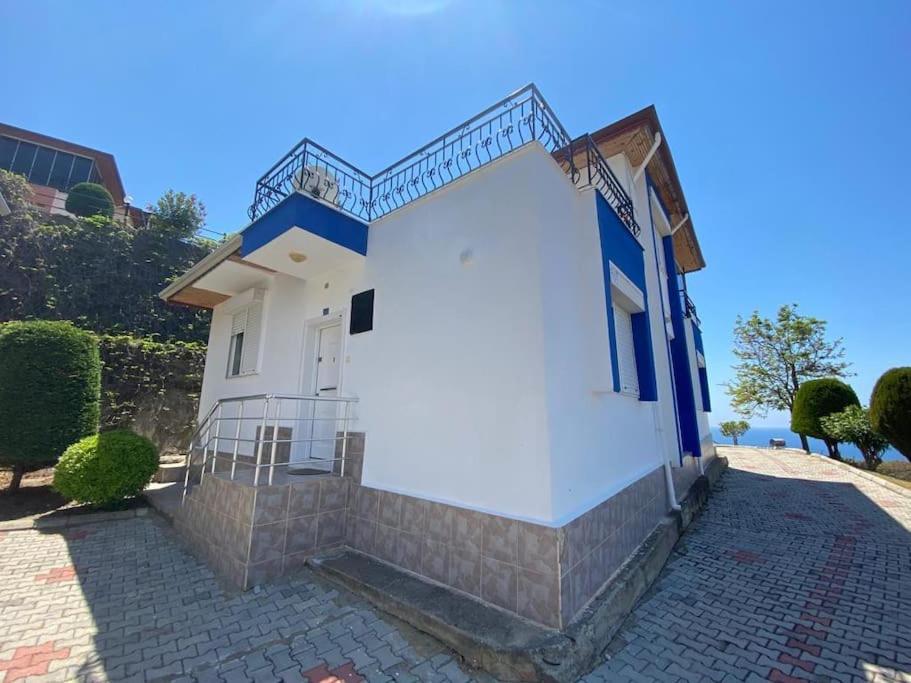 加济帕夏Turkish riviera sea view detached villa的白色和蓝色的建筑,上面有楼梯