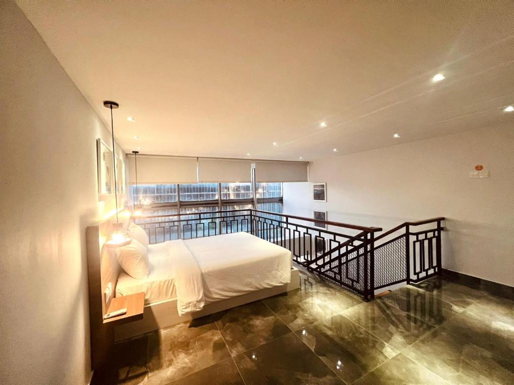 巴淡岛中心Oxy suites 2-02 at Shop House Meisterstadt Pollux Habibie的阳台卧室(带一张床)
