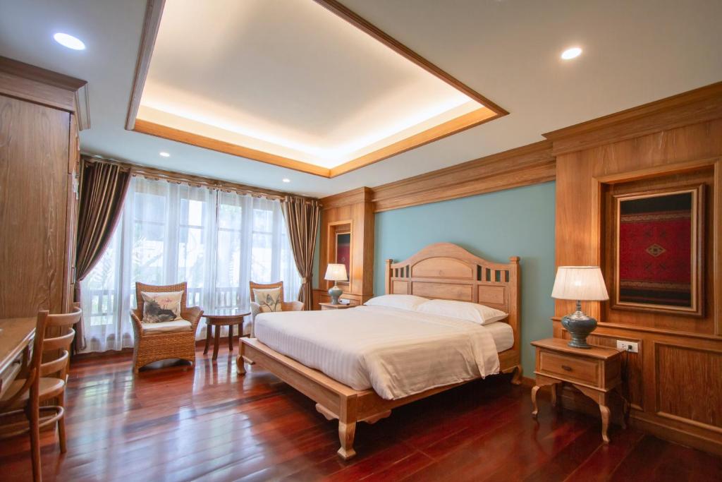 清迈富园之家酒店的卧室配有一张床和一张桌子及椅子