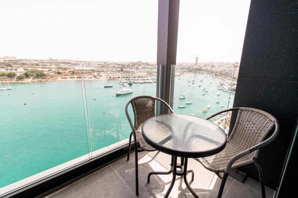 斯利马The Londoner Hotel Sliema的海港景阳台的桌椅