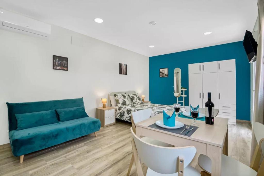 阿利坎特Umihouse apartamentos centro Alicante的客厅配有蓝色的沙发和桌子