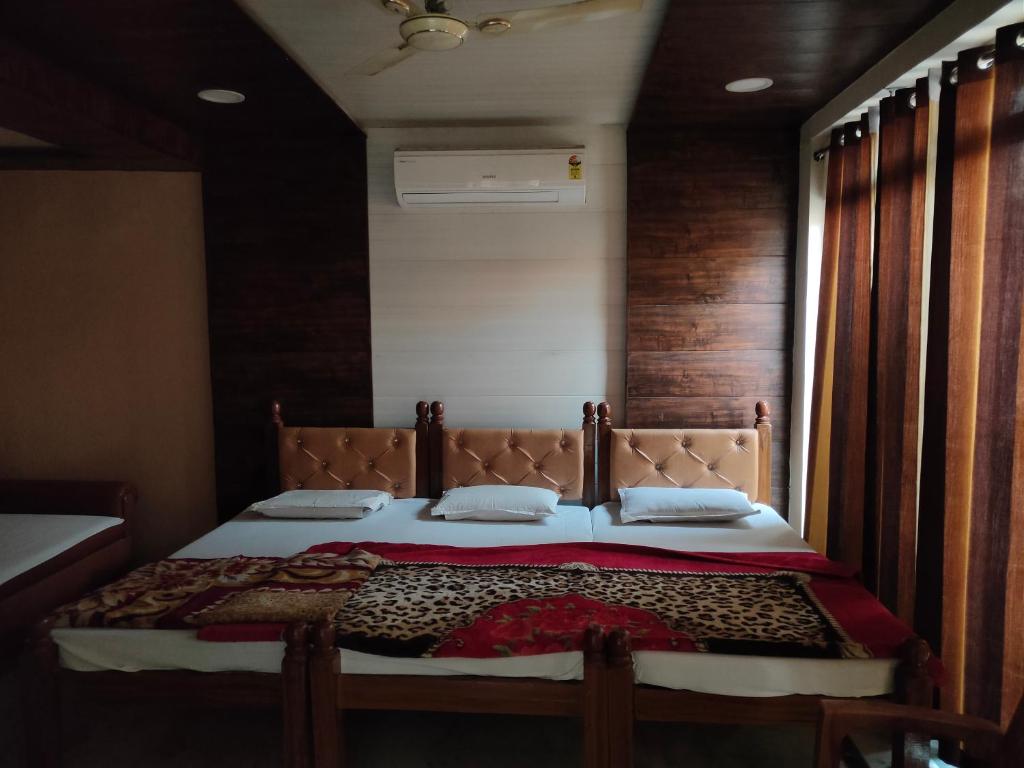 马图拉Hotel Shubhadra Guest House的一间卧室设有一张带木墙的大床