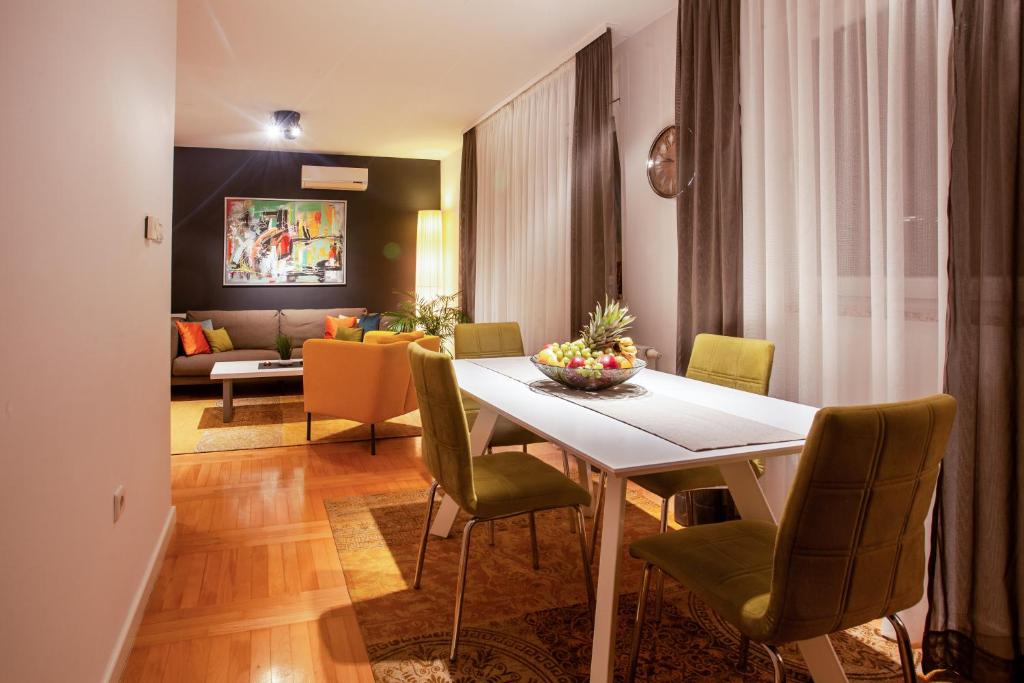 锡萨克Apartment Sladic的一间带桌椅和沙发的用餐室