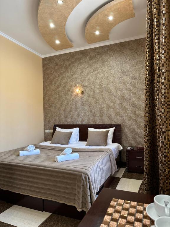埃里温Royal Plus Hotel的一间卧室配有一张床,上面有两条毛巾