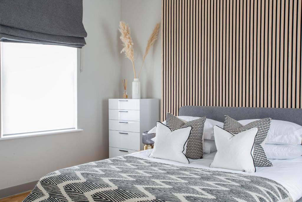 伦敦Eden Grove - Islington - Studio Apartment的卧室配有带枕头的床铺和窗户。