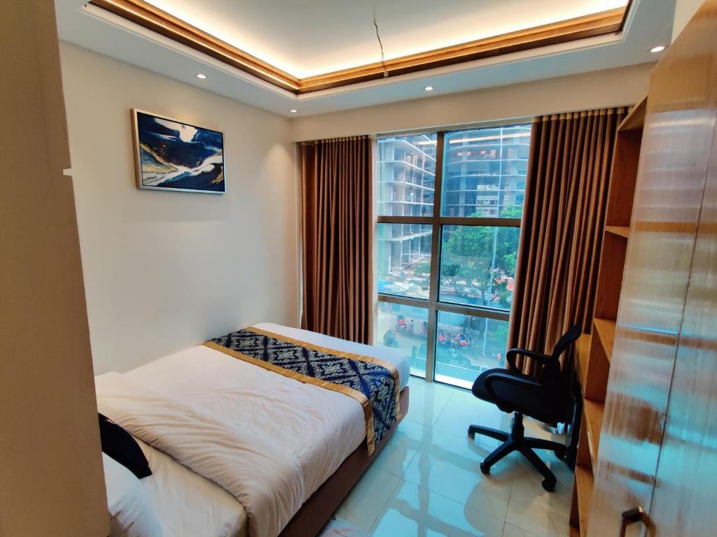 达卡Hotel Royal Bengal的一间卧室配有一张床、一张书桌和一个窗户。