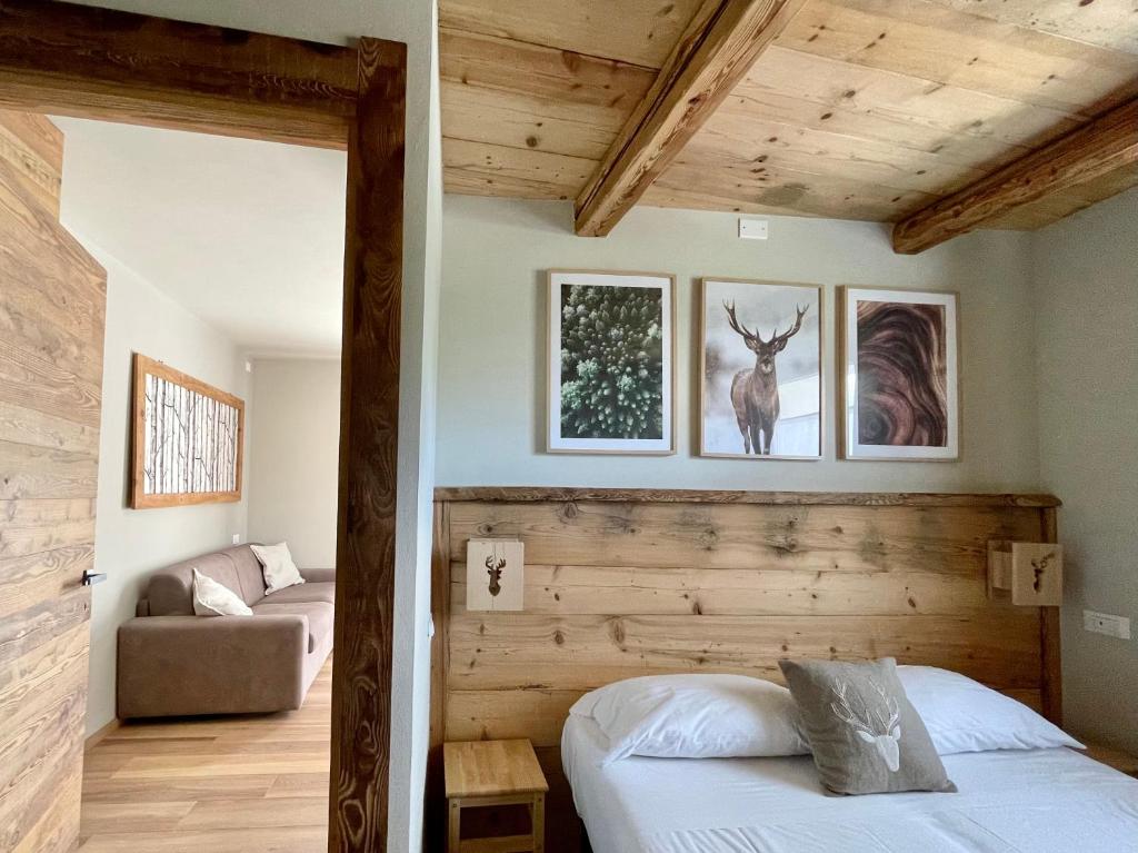 巴多尼奇亚La Maison - Il Riparo del Cervo的一间卧室配有一张床和一个沙发